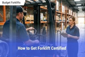 Female warehouse supervisor with a clipboard talking to a male forklift driver in a busy industrial aisle.
