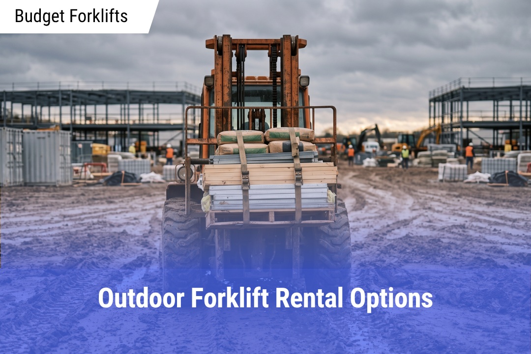 Rear view of an orange rough terrain forklift moving strapped wooden planks and bags of concrete across a rutted, muddy construction jobsite under a cloudy sky.
