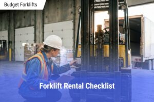 Warehouse supervisor wearing a hard hat and safety vest crouching beside a counterbalance forklift to inspect its data plate and mast chains at a loading dock.